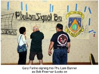 P009-Brigade 2016Reunion BobMotley-Gary Farino signing Phu Lam Banner as Bob Freeman looks on